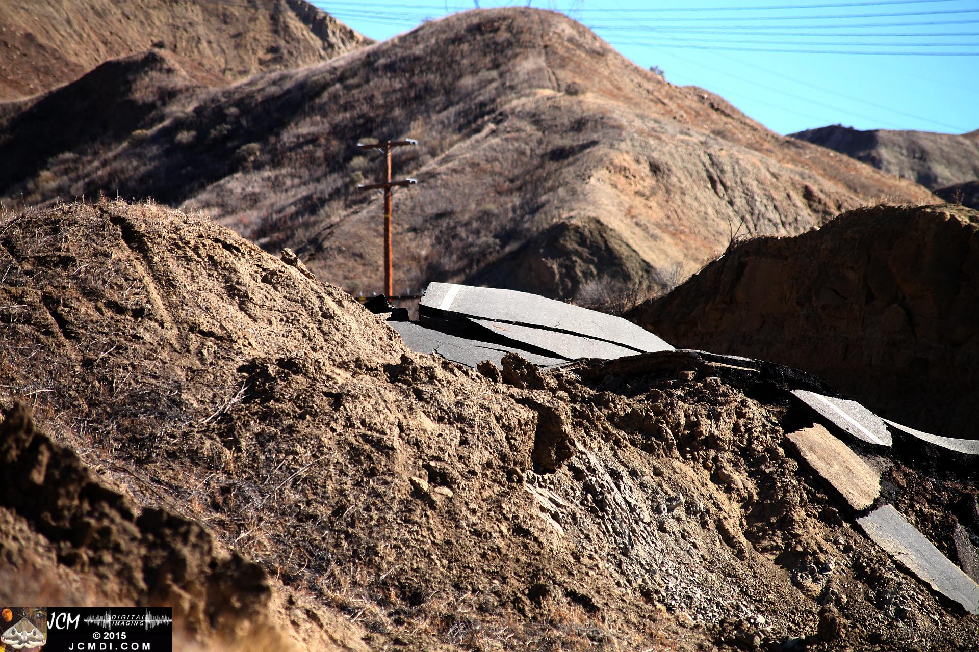 Landslide, buckled pavement, and terrain at Vasquez Canyon Road in Santa Clarita, CA filmed 11-25-2015